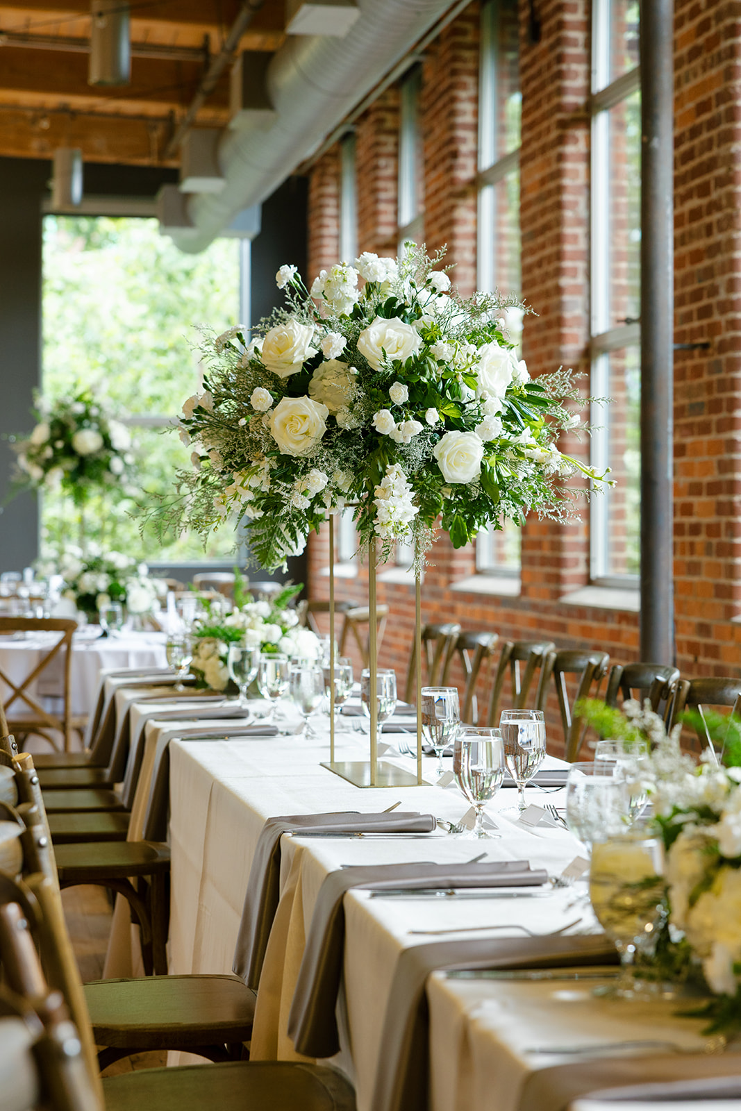 beautiful white floral installations on the wedding reception tables 