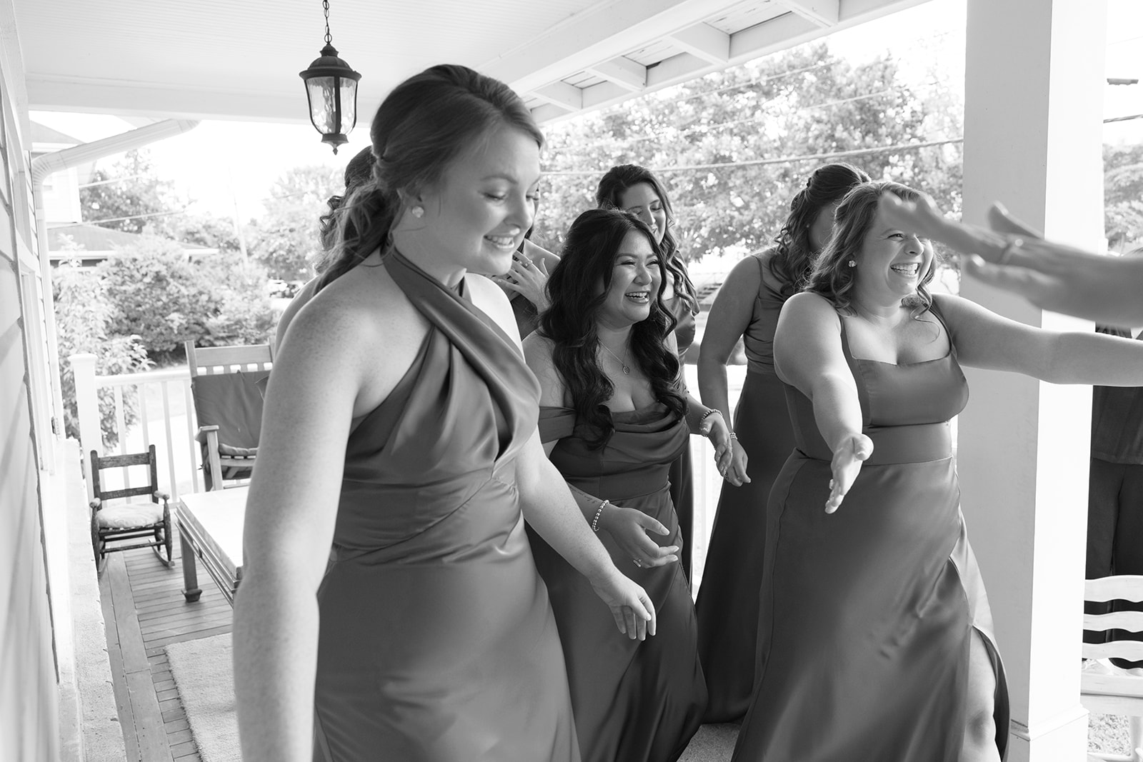 the bridesmaids reaching out to hug the bride 