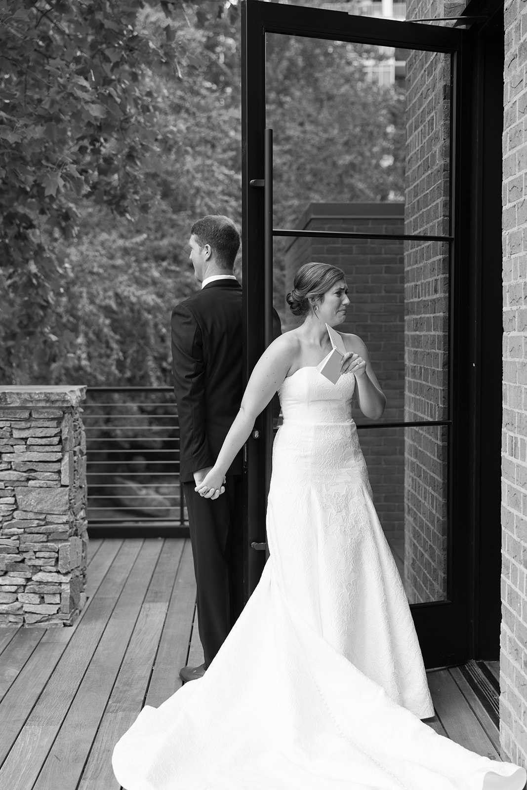 the bride getting emotional as her and the groom share a first touch during their Greenville wedding 