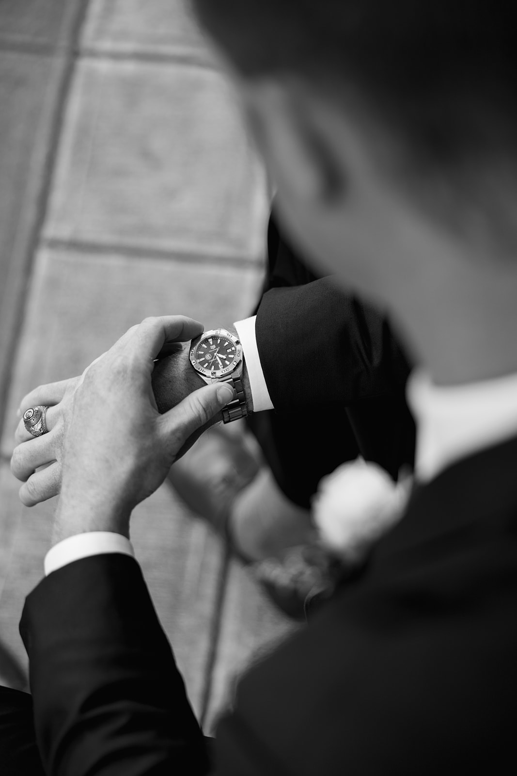 a groom checking his watch during his groom portraits 