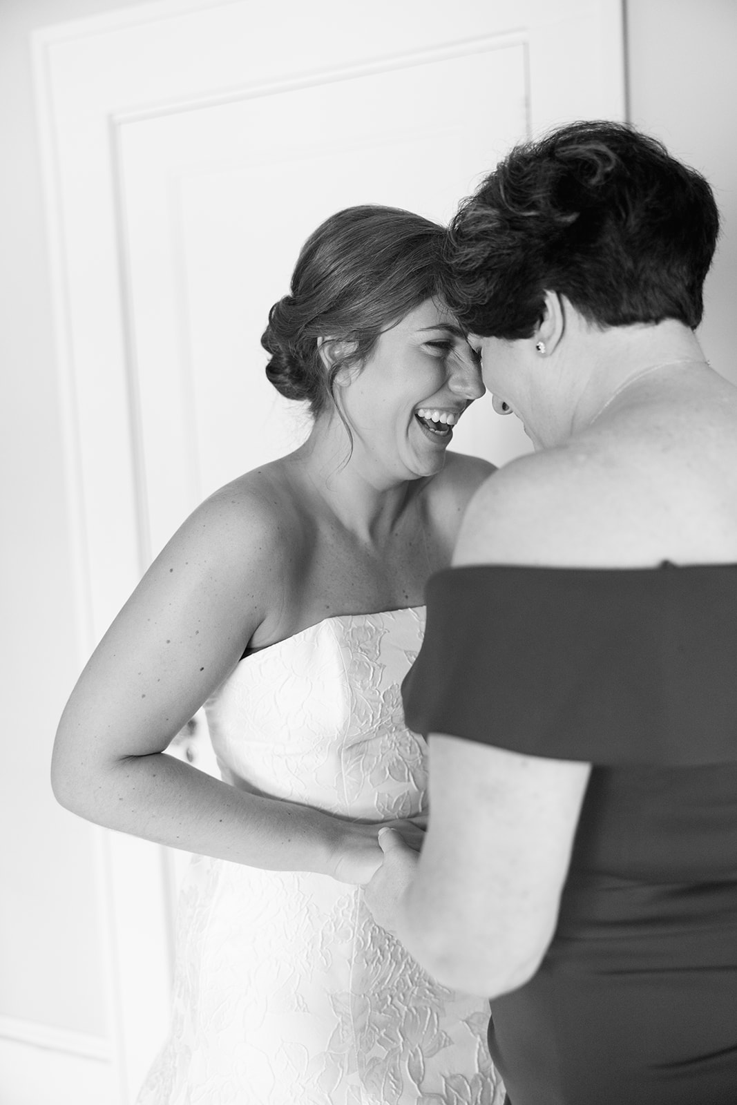 the bride and her mother sharing a candid moment 