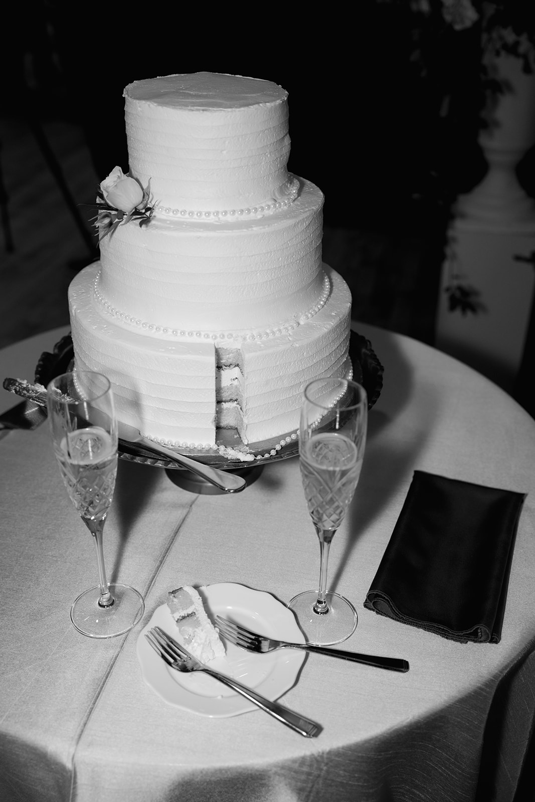 the wedding cake after a piece has been cut out 