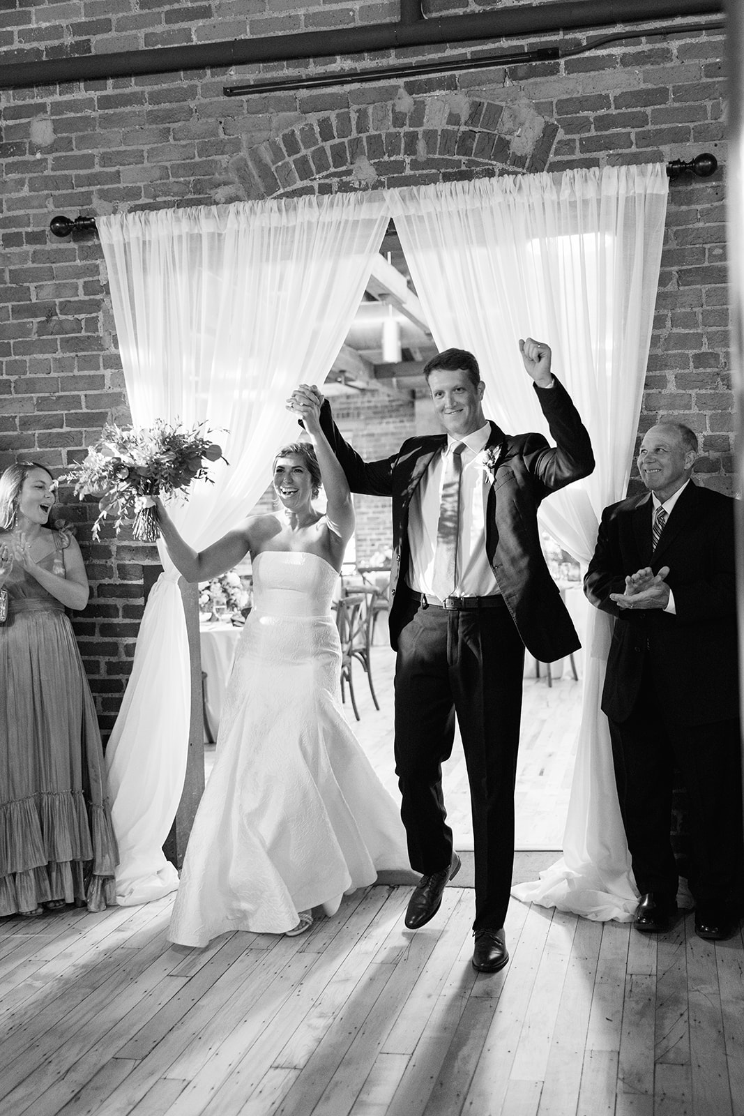 the bride and groom entering their reception during the Greenville Wedding Photography Timeline