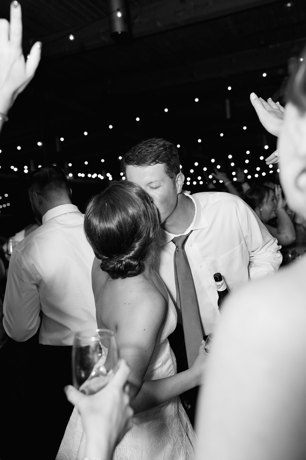 the bride and groom kissing at the reception