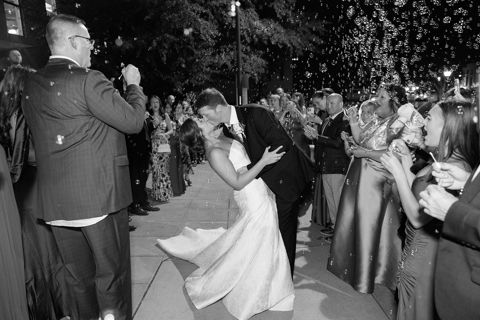 the groom dipping the bride during their wedding exit 