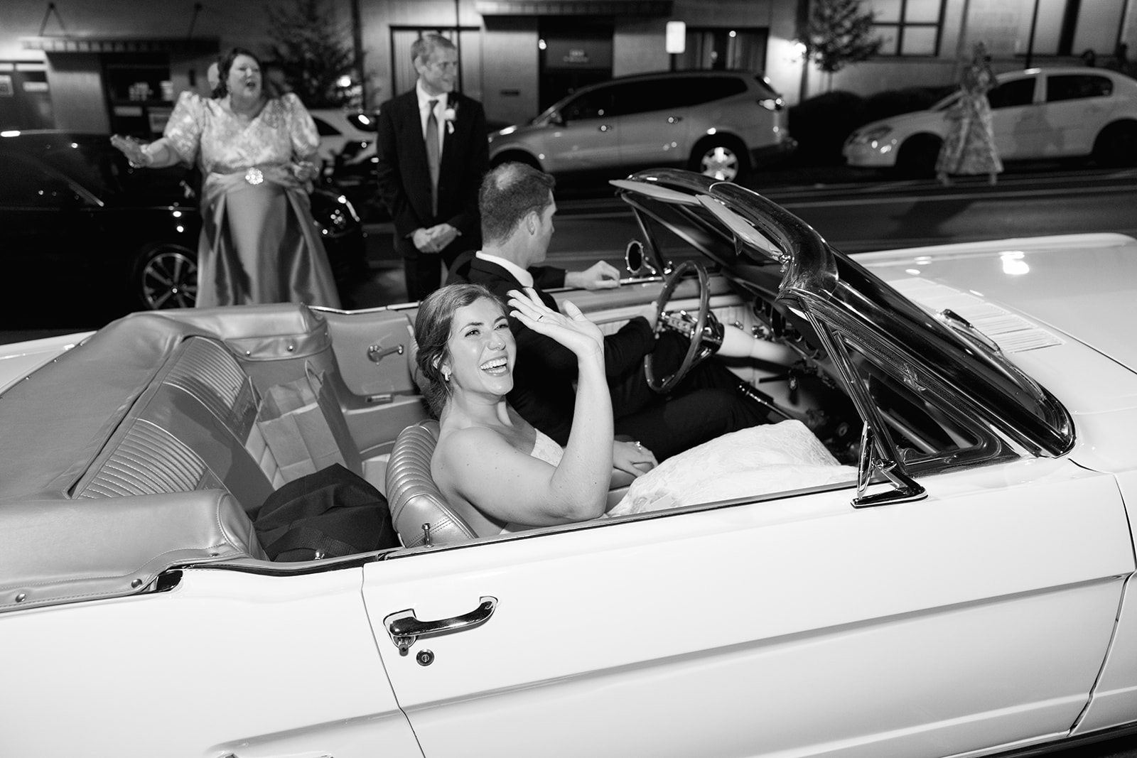 the bride and groom getting into their classic car for their send off 
